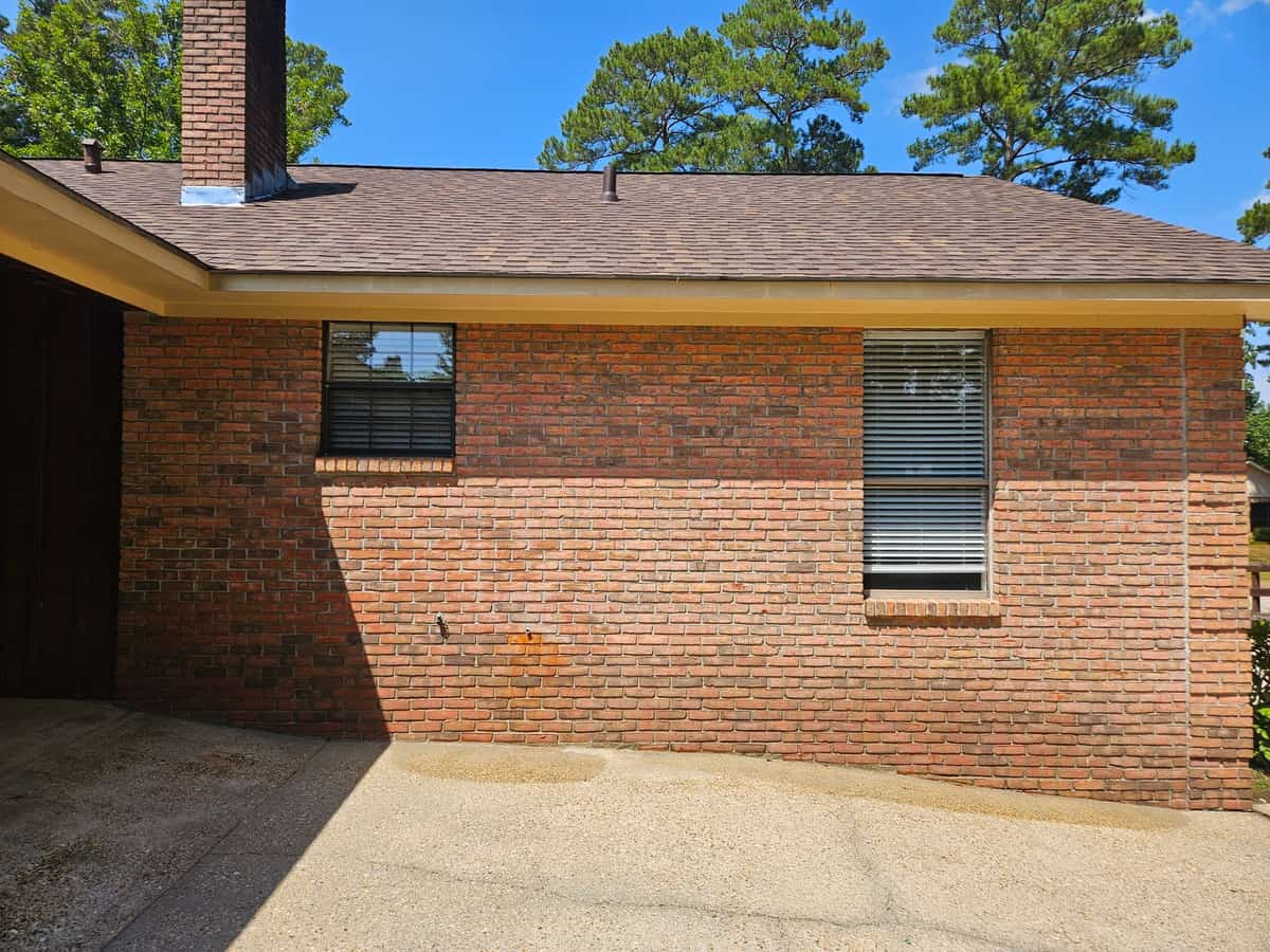 Brick side wall and concrete at a completed Collins exterior-cleaning project